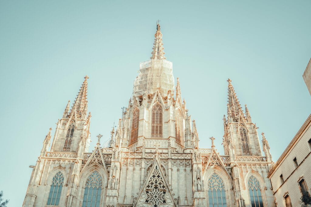 Low-angle view of a famous Gothic cathedral's facade in Barcelona, capturing intricate architecture.